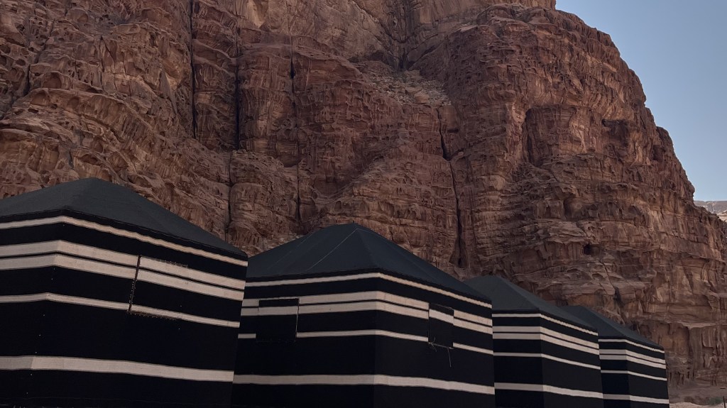 The iconic black goat-hair tents can still be seen in the desert.